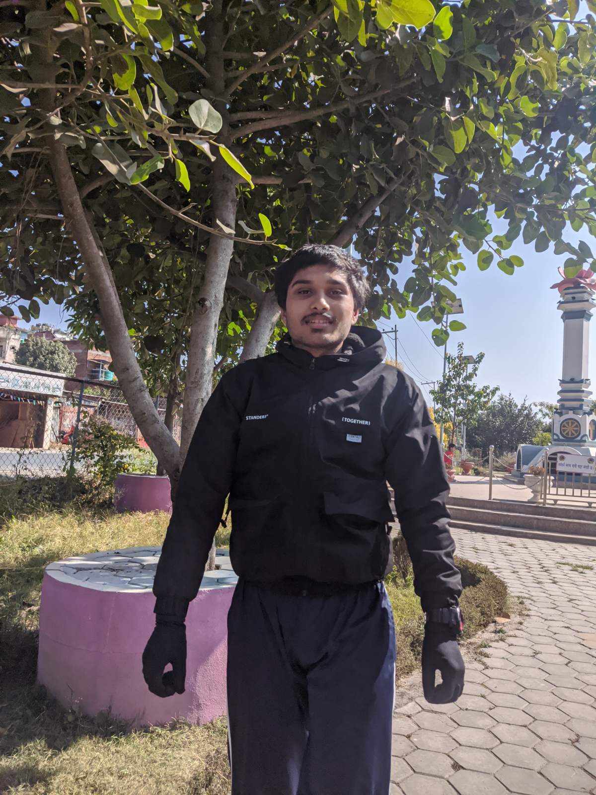Whitney leaning against a railing on a downtown street
